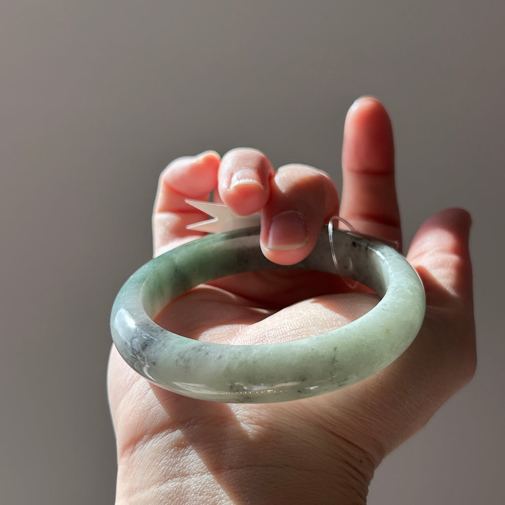Floating green Burmese jadeite bangle with black chicken (wuji), 58.6mm, photo 3 - Luxe Jadeite