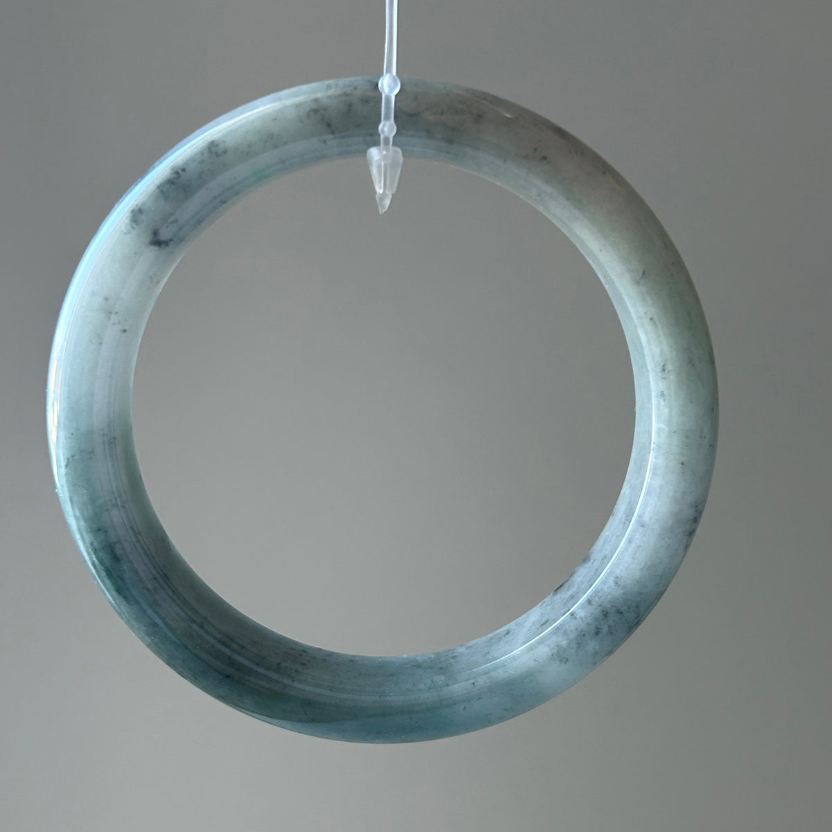 Floating green Burmese jadeite bangle with black chicken (wuji), 58.6mm - Luxe Jadeite