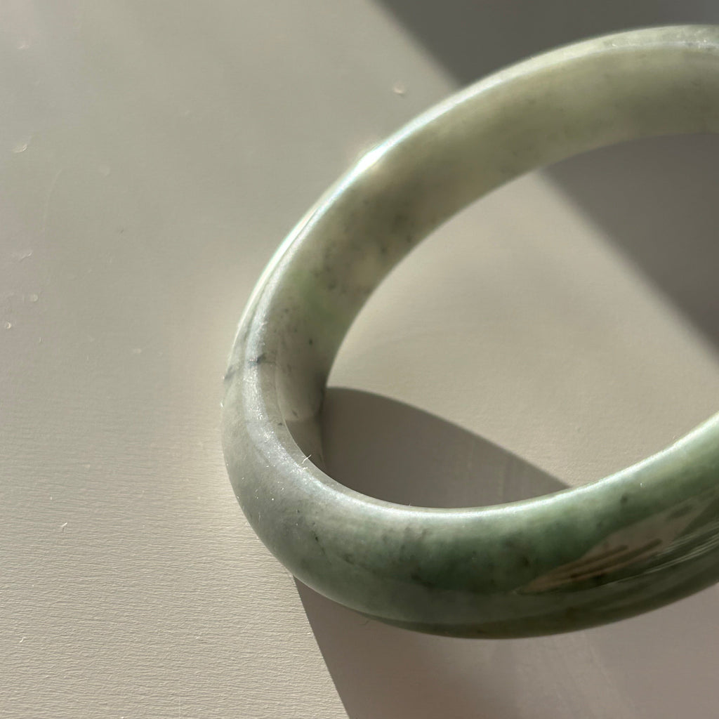 Floating green Burmese jadeite bangle with black chicken (wuji), 58.6mm, photo 3 - Luxe Jadeite