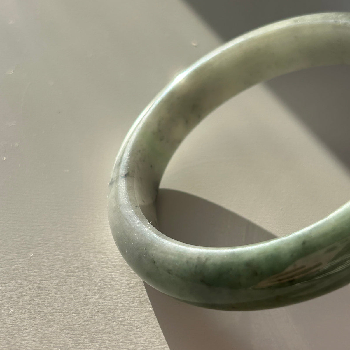 Floating green Burmese jadeite bangle with black chicken (wuji), 58.6mm, photo 3 - Luxe Jadeite