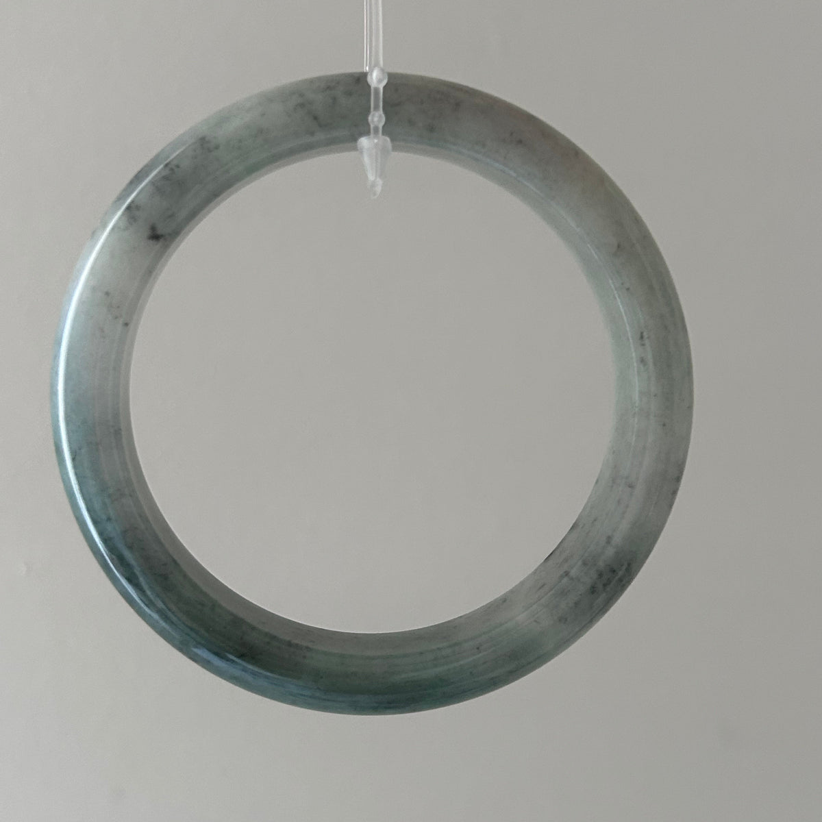 Floating green Burmese jadeite bangle with black chicken (wuji), 58.6mm - Luxe Jadeite