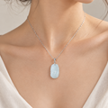 Small Light Green Ruyi Pendant in Sterling Silver, photo 1 - Luxe Jadeite