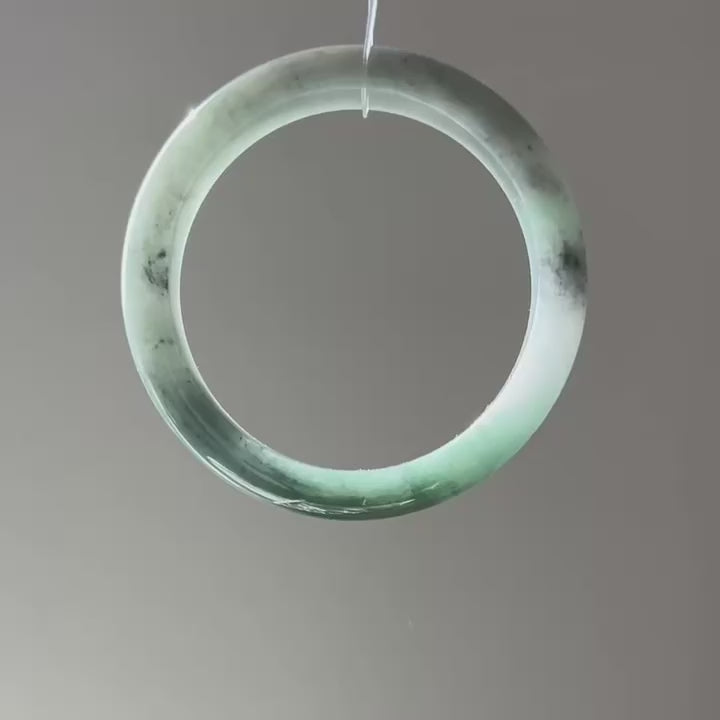 Floating green Burmese jadeite bangle with black chicken (wuji), 58.6mm, video 2 - Luxe Jadeite